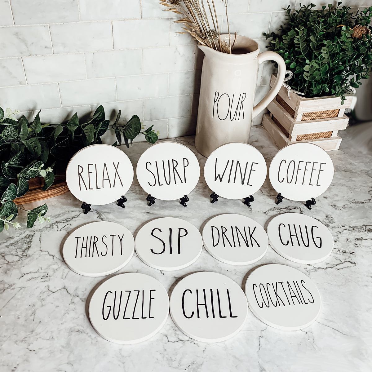 A stylish set of ceramic coasters with cork backing, featuring various fun designs for kitchen decor.