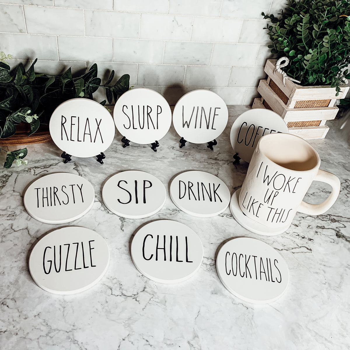 A stylish set of ceramic coasters with cork backing, featuring various fun designs for kitchen decor.