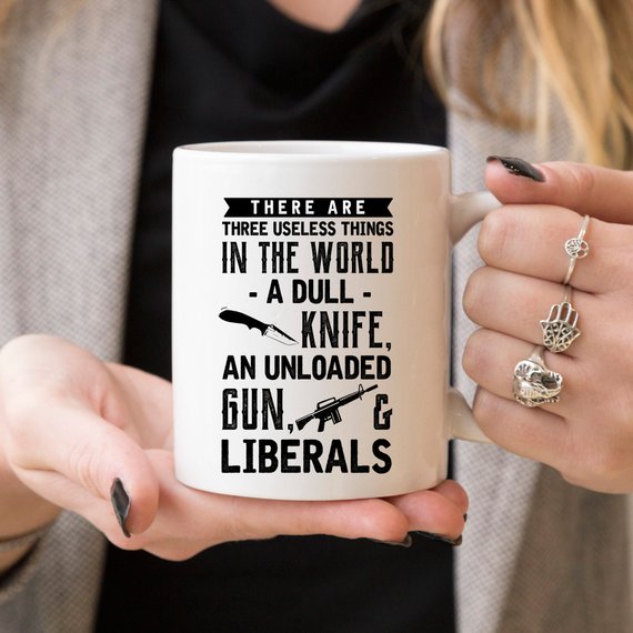 Funny coffee mug featuring the phrase 'There Are Three Useless Things In The World, A Dull Knife, Unloaded Gun & Liberal', crafted from high-quality ceramic.