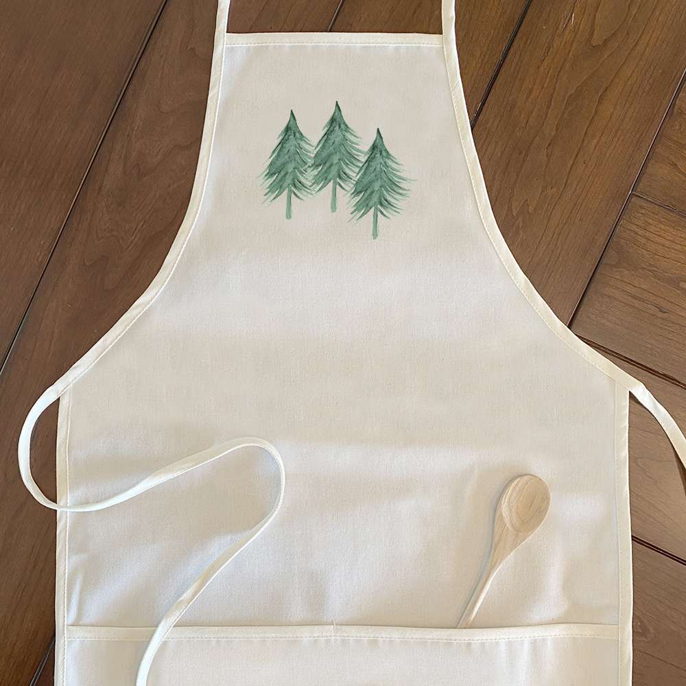 Three Trees Women's Apron in cotton canvas with natural twill ties and divided front pocket, showcasing an elegant design.