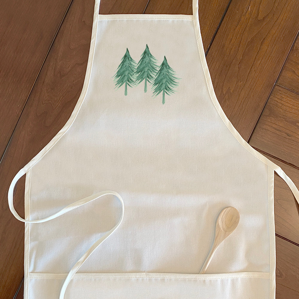 Three Trees Women's Apron in cotton canvas with natural twill ties and divided front pocket, showcasing an elegant design.