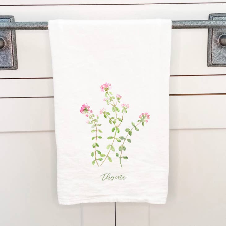 Thyme Cotton Tea Towel featuring a vibrant thyme design, made from 100% absorbent cotton, displayed on a kitchen countertop.