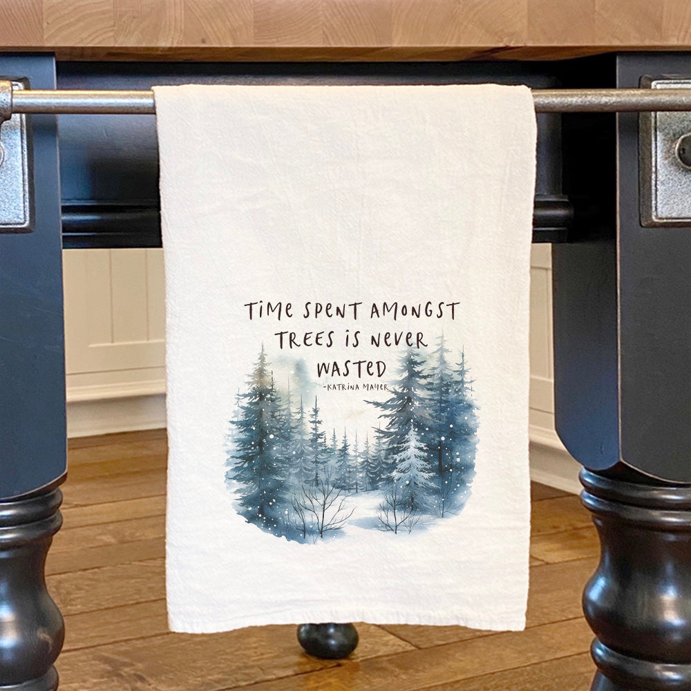 A beautifully designed cotton tea towel featuring a nature-inspired print, showcasing vibrant colors and hemmed edges, perfect for kitchen use.