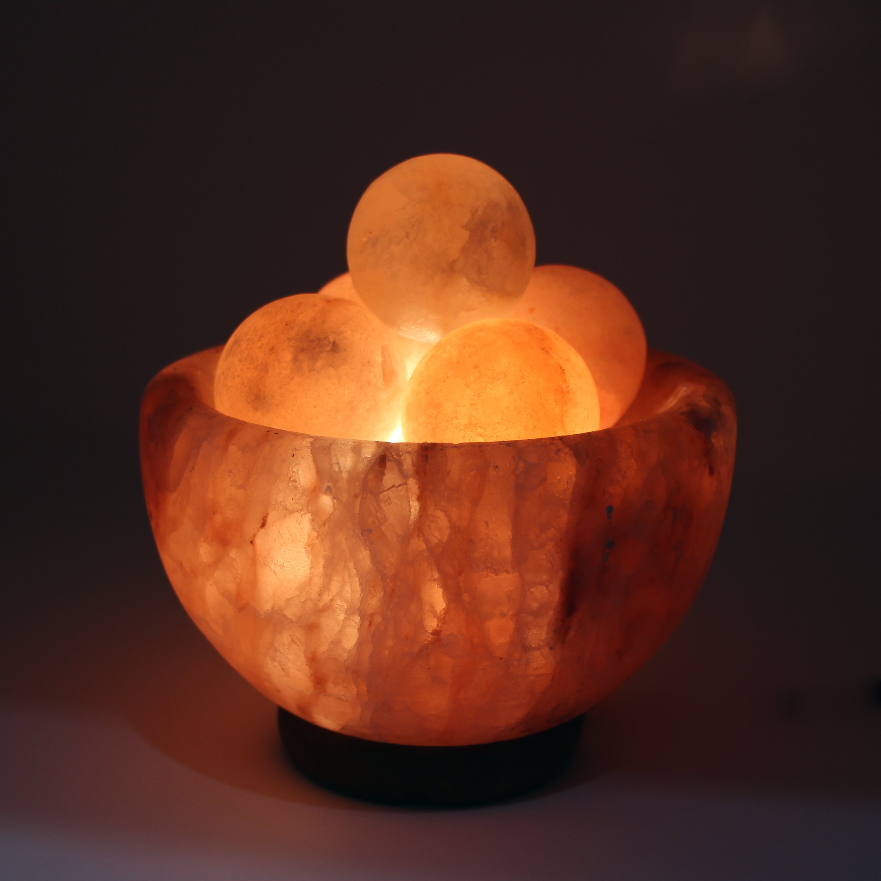 UMAID Natural Himalayan Rock Sea Salt Lamp Bowl with 6 heated massage balls, showcasing a warm amber glow and handcrafted design.