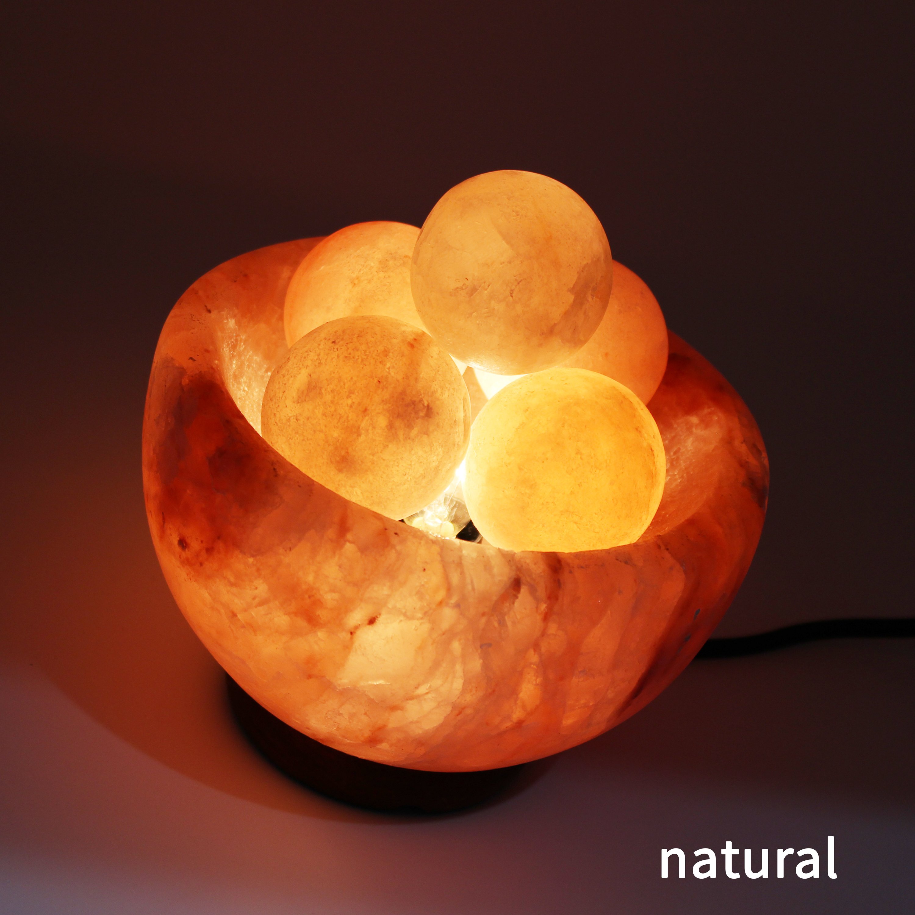 UMAID Natural Himalayan Rock Sea Salt Lamp Bowl with 6 heated massage balls, showcasing a warm amber glow and handcrafted design.