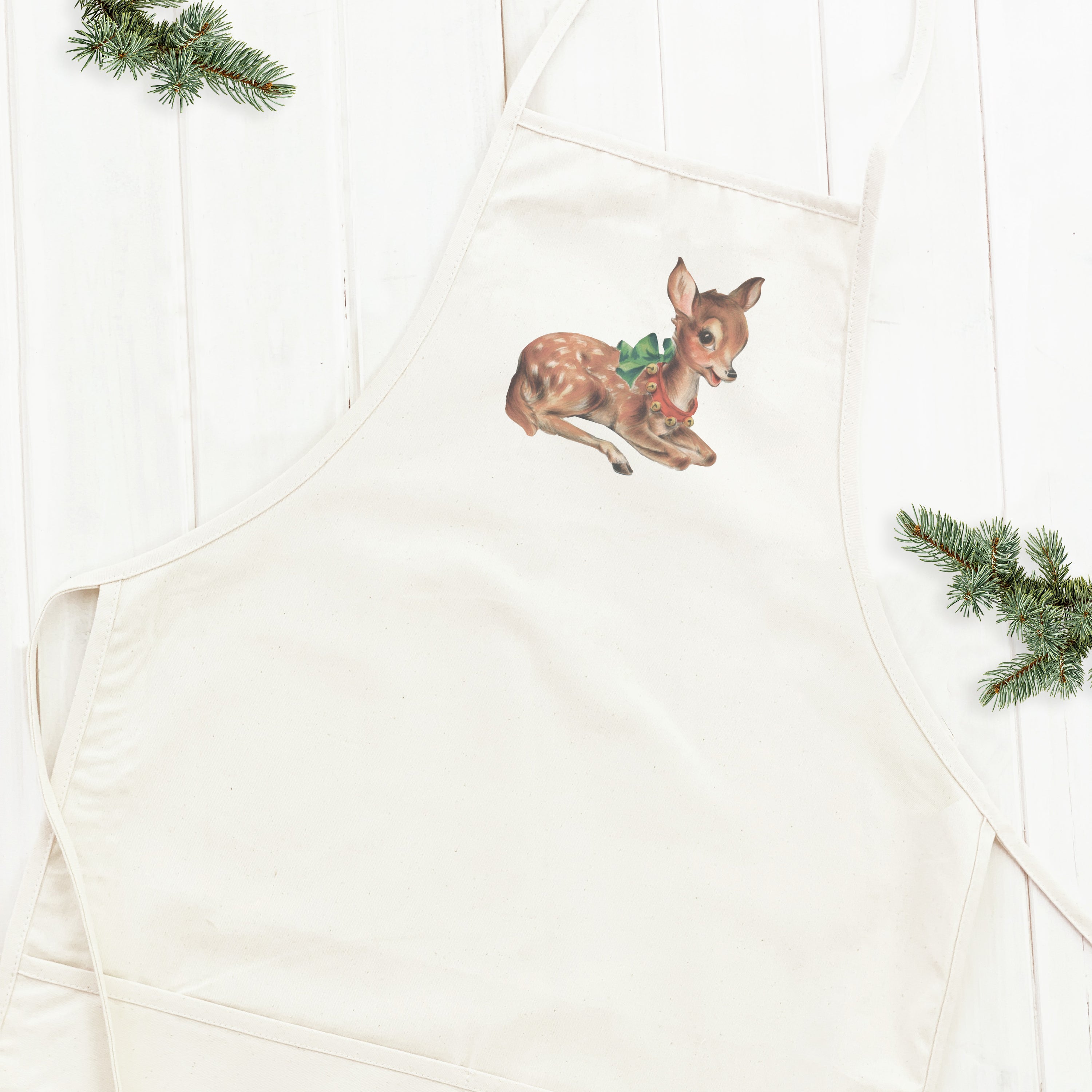 Vintage Reindeer Women's Apron featuring a charming reindeer print, adjustable neck strap, and divided front pocket, made from durable cotton canvas.