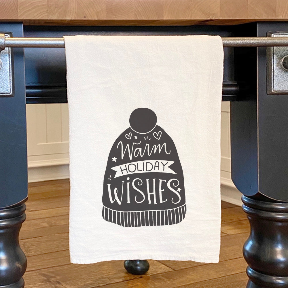 Warm Holiday Wishes cotton tea towel featuring a vibrant holiday design, made from 100% absorbent cotton, perfect for kitchen use.