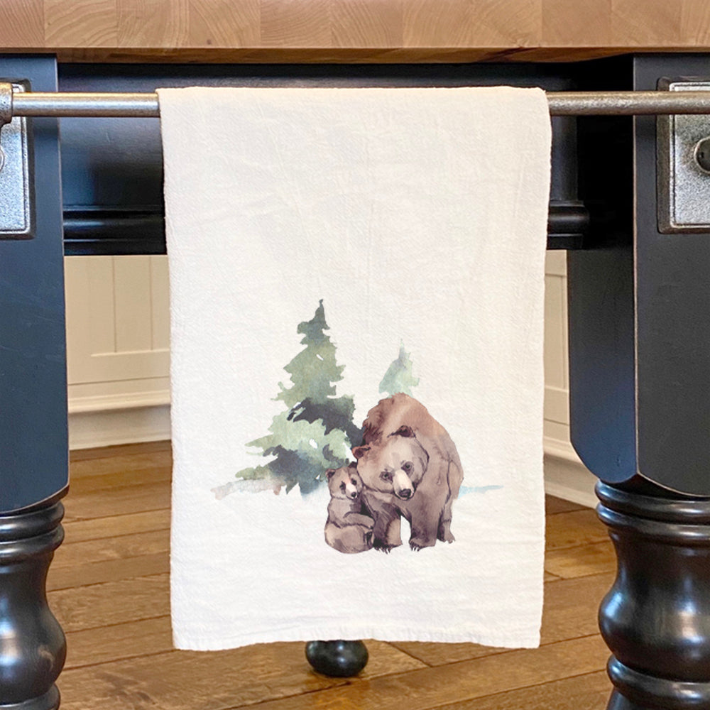 A beautifully designed cotton tea towel featuring a vibrant watercolor bear scene, perfect for kitchen use.