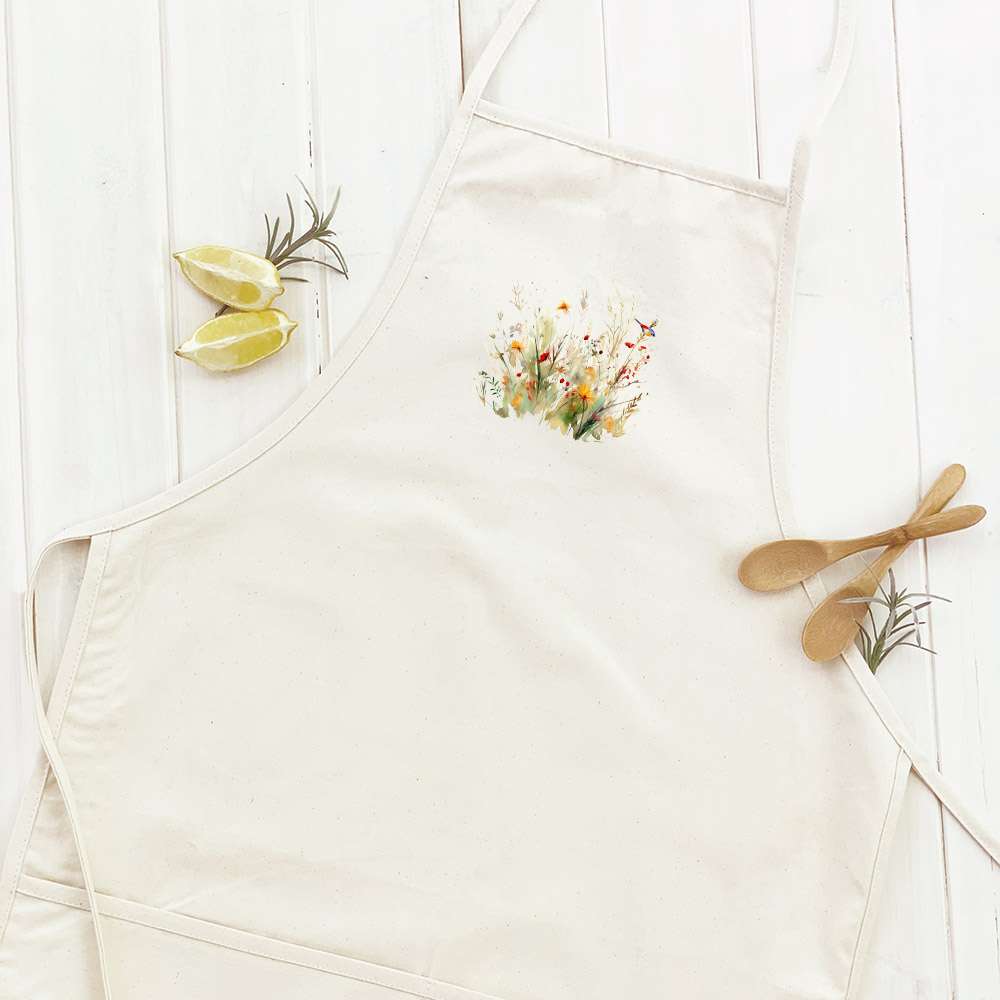 A stylish women's apron featuring a watercolor bird and wildflowers design, made from durable cotton canvas with adjustable ties.