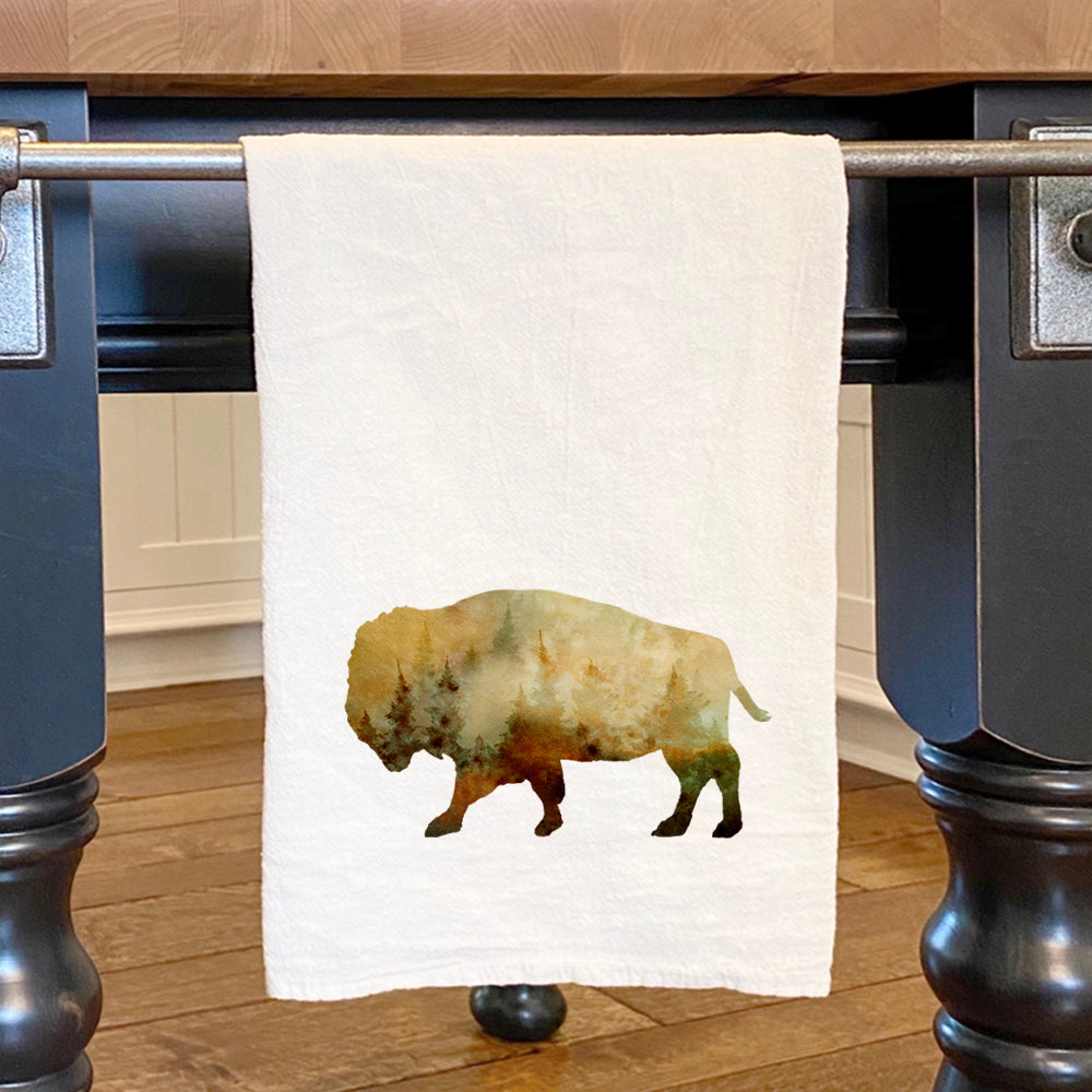 A vibrant watercolor buffalo design on a cotton tea towel, showcasing its absorbent texture and hemmed edges.