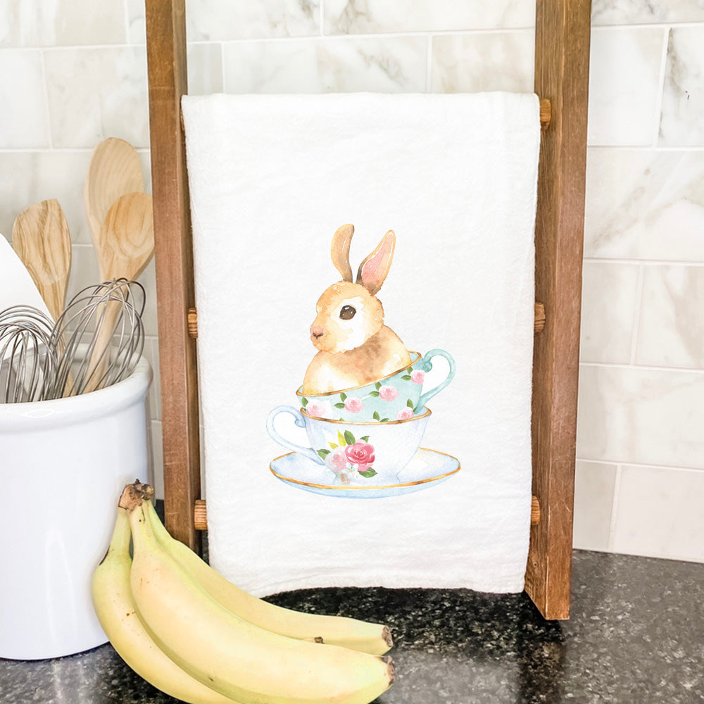 A charming Watercolor Bunny Teacup cotton tea towel featuring a vibrant bunny design, perfect for kitchen use.