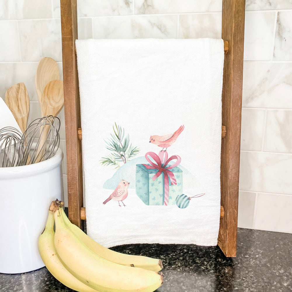 A vibrant cotton tea towel featuring watercolor Christmas birds design, perfect for holiday kitchen decor.