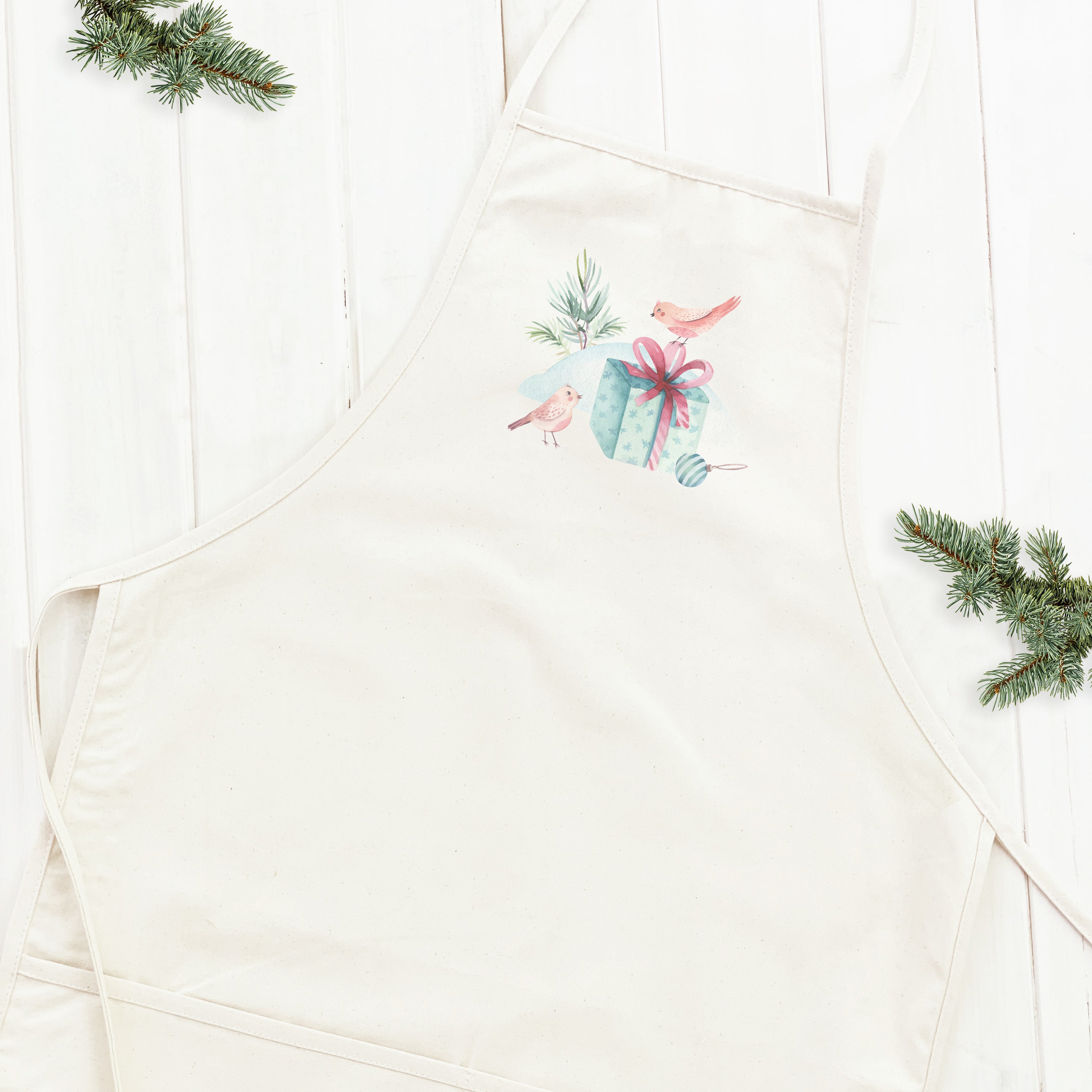 A stylish women's apron featuring a watercolor design of Christmas birds, made from durable cotton canvas with adjustable neck and twill ties.