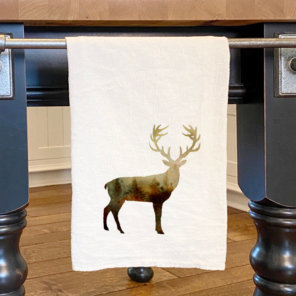 A beautifully designed cotton tea towel featuring a watercolor deer, showcasing vibrant colors and hemmed edges, perfect for kitchen use.