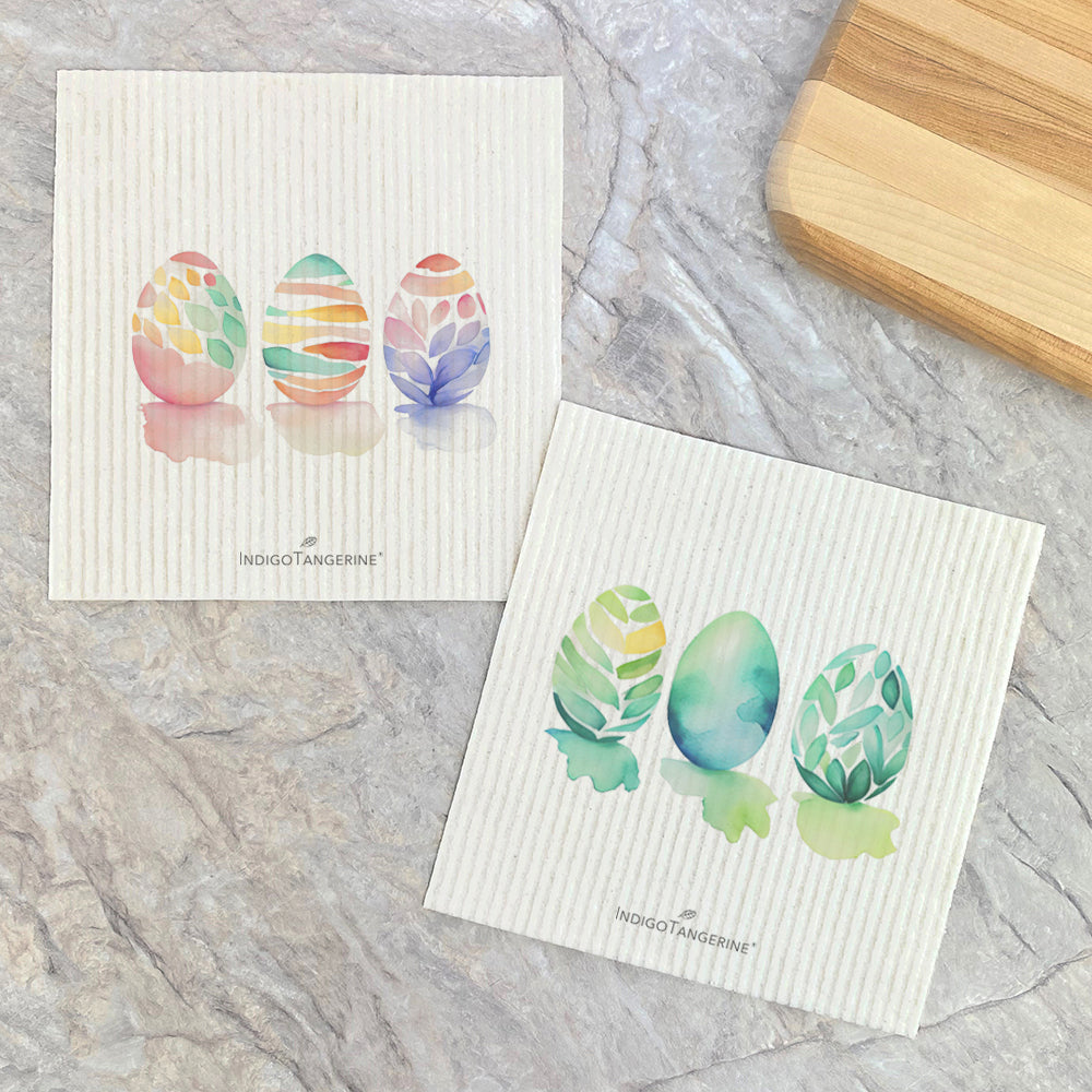 Two Swedish dishcloths featuring watercolor Easter egg designs, eco-friendly and reusable.