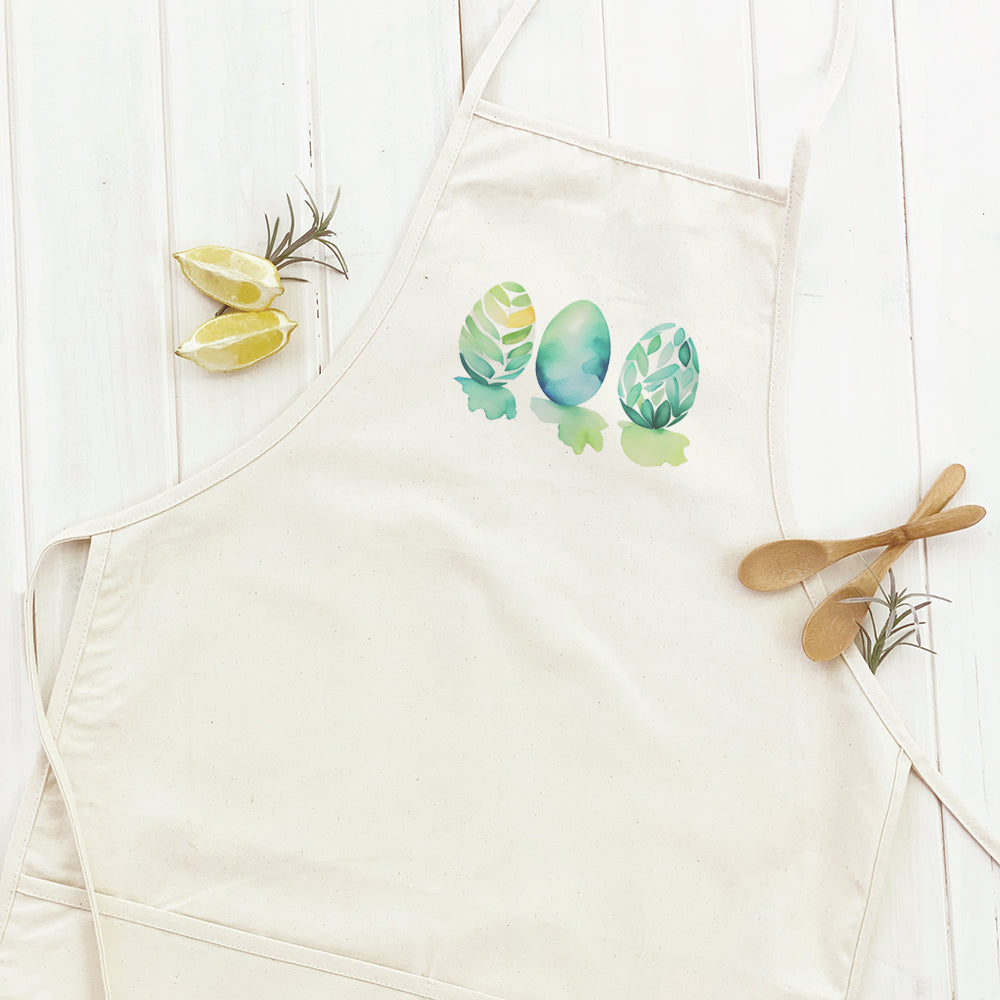 A stylish women's apron featuring a watercolor Easter egg design, made from durable cotton canvas with natural twill ties.