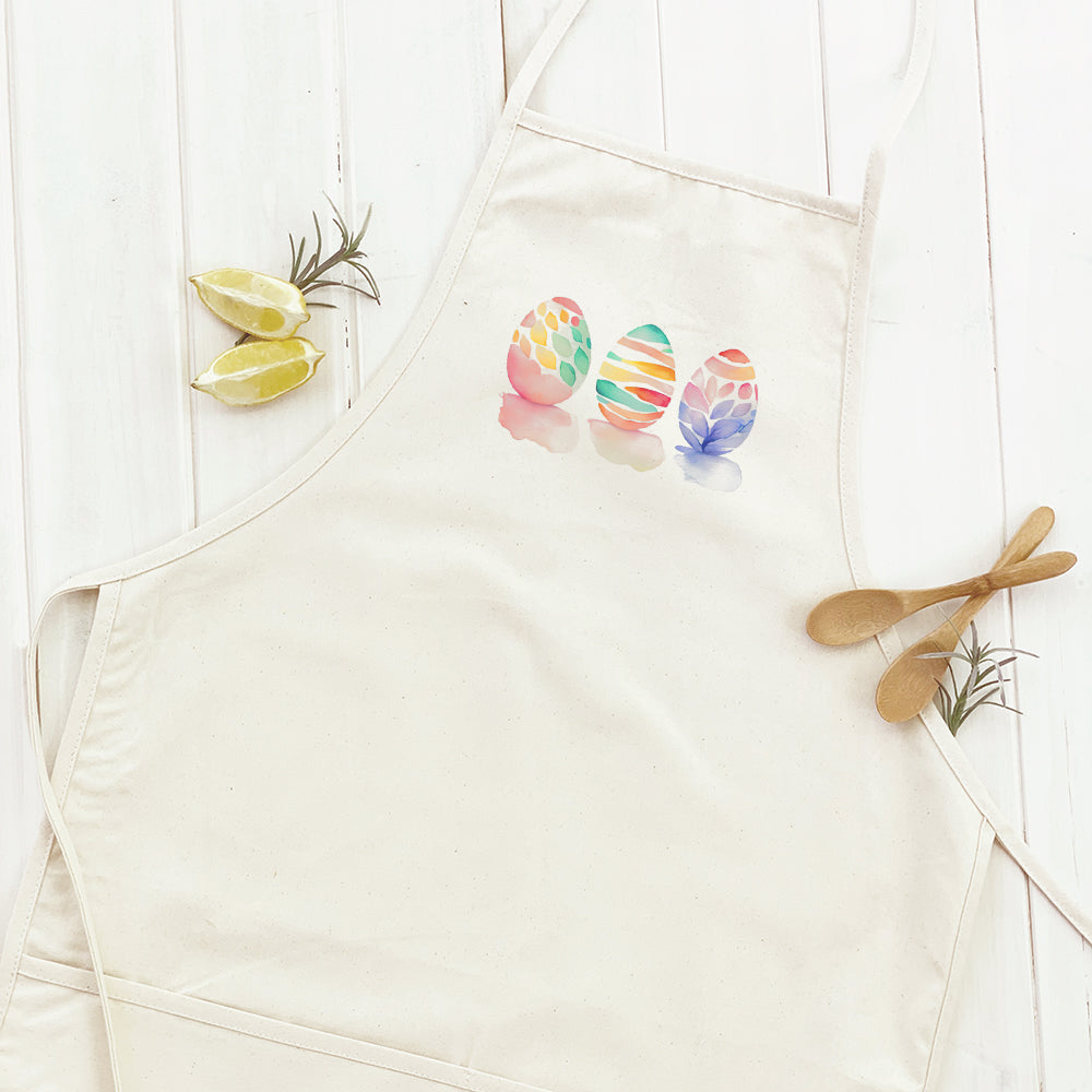 A stylish women's apron featuring a watercolor Easter egg design, made from durable cotton canvas with adjustable neck and twill ties.