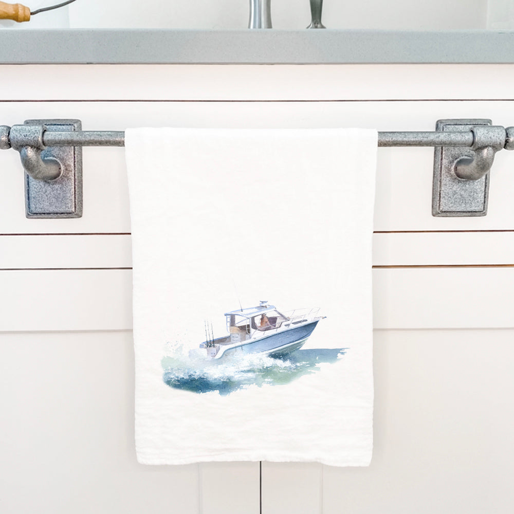 A vibrant cotton tea towel featuring a watercolor illustration of a fishing boat, showcasing its absorbent texture and hemmed edges.