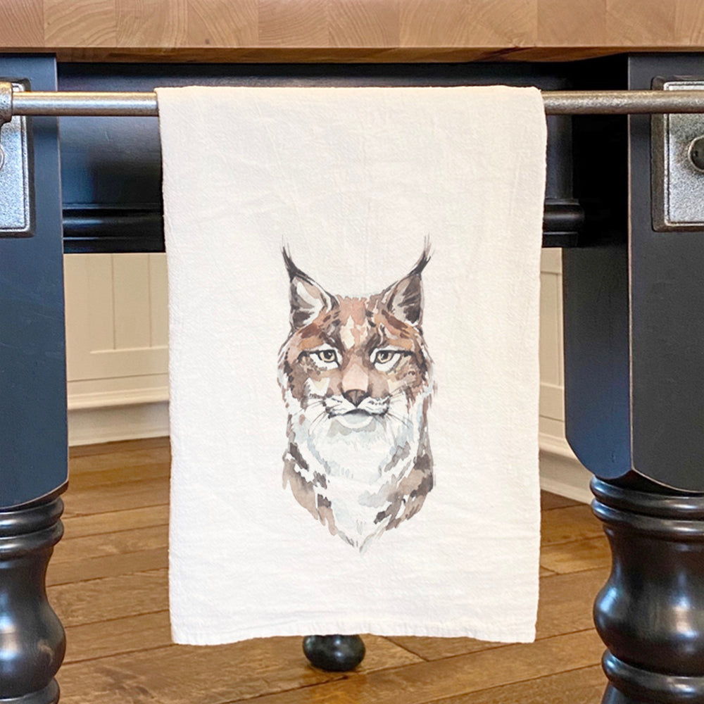 A vibrant watercolor design of a lynx on a 100% cotton tea towel, showcasing its absorbent and stylish features.