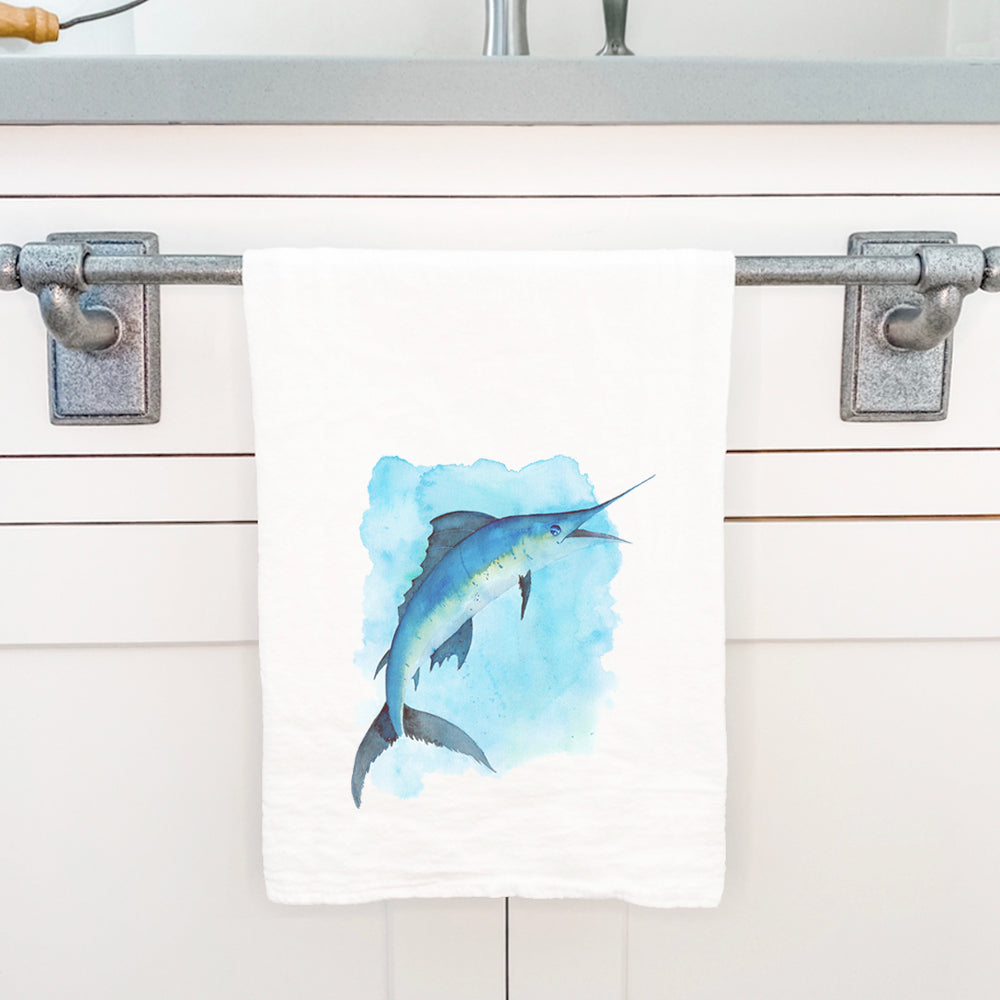 A vibrant watercolor marlin design on a 100% cotton tea towel, showcasing its absorbent texture and hemmed edges.