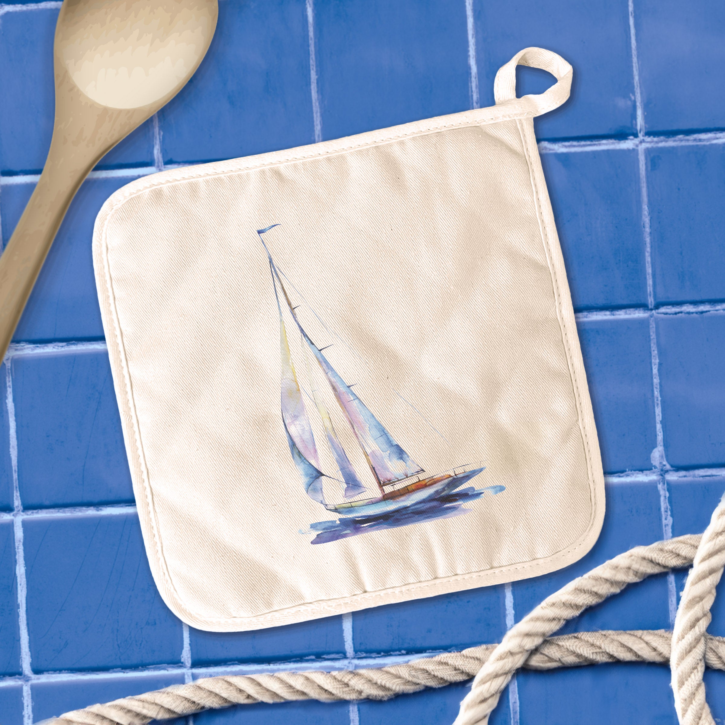 A vibrant blue watercolor sailboat design on a cotton pot holder, showcasing its square shape and hanging loop.