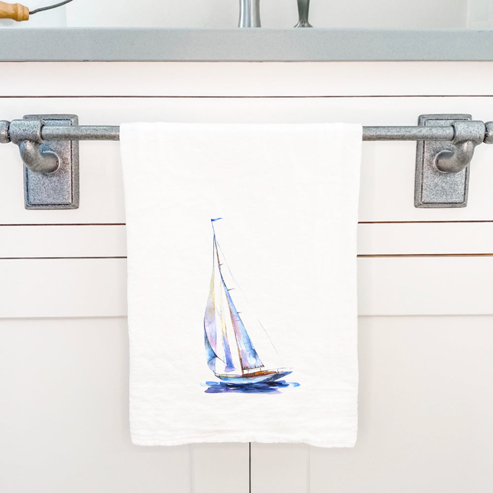 A vibrant watercolor sailboat design on a 100% cotton tea towel, showcasing nautical themes in blue hues.