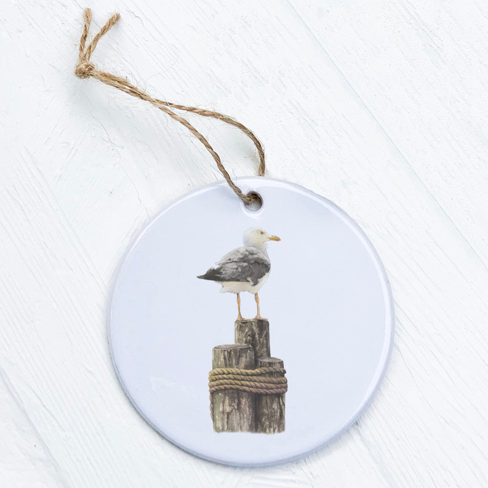 A beautifully crafted porcelain ornament featuring a watercolor seagull design, showcasing vibrant colors and a smooth finish.