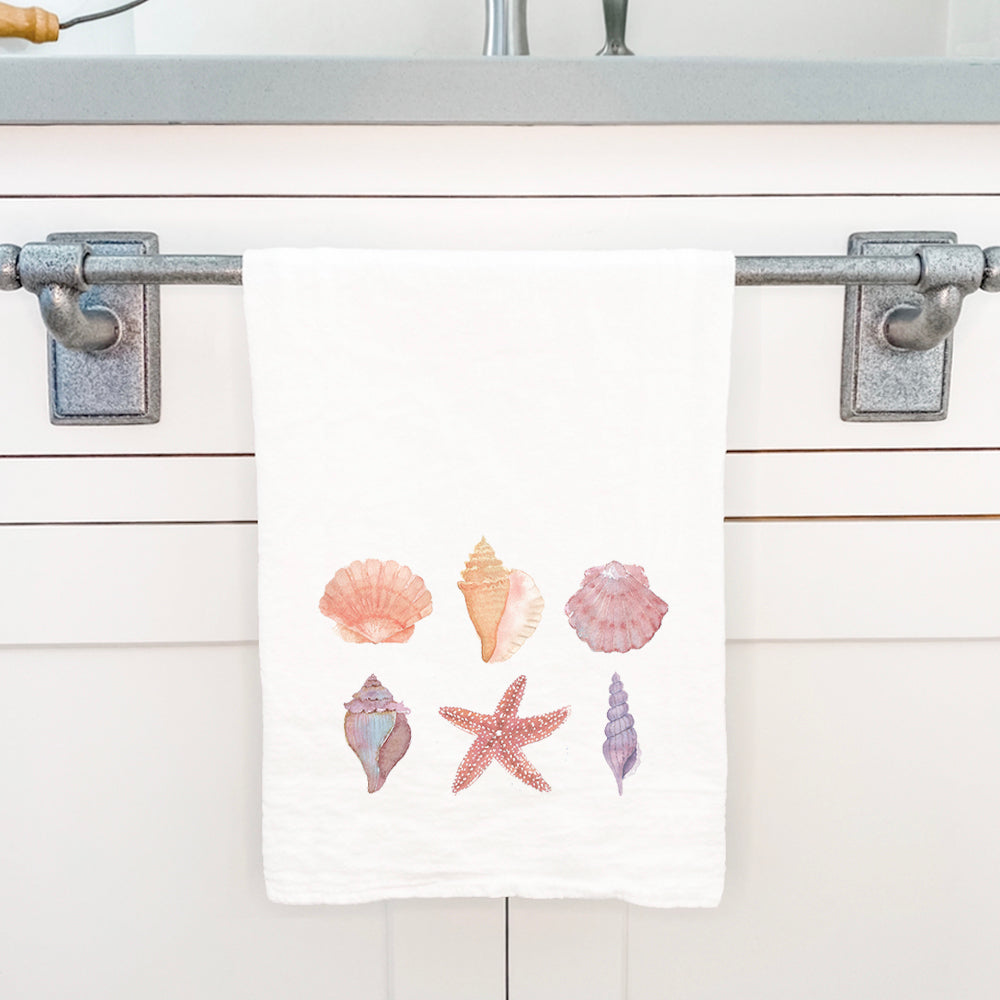 A vibrant cotton tea towel featuring a watercolor shell design, perfect for kitchen use.