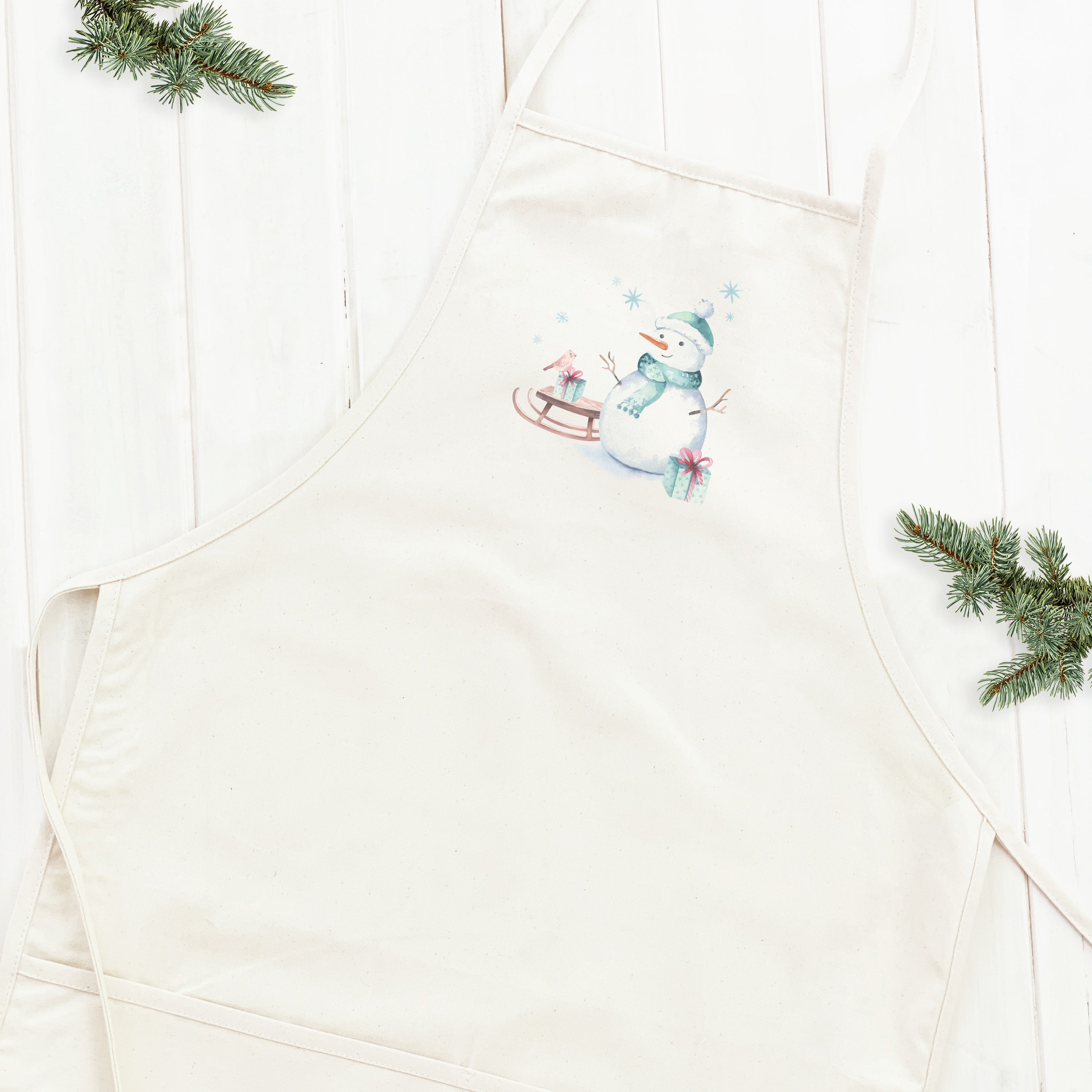 A stylish Watercolor Snowman Women's Apron featuring a whimsical snowman design, made from durable cotton canvas with adjustable ties.