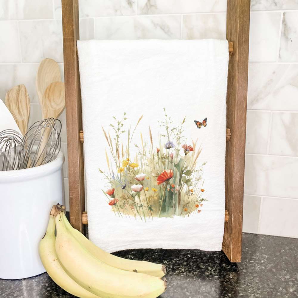 A vibrant cotton tea towel featuring a watercolor wildflower grass design, perfect for kitchen use.