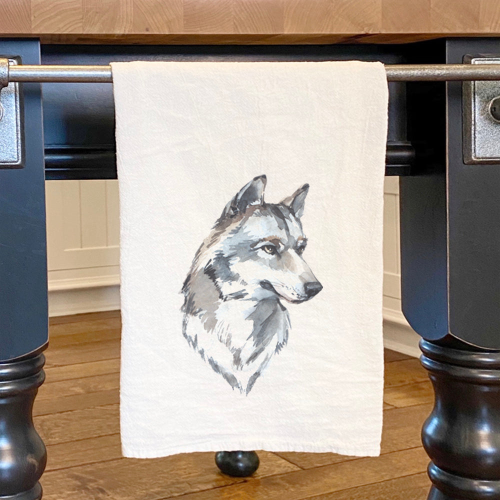 A vibrant watercolor illustration of a wolf's head on a cotton tea towel, showcasing intricate details and colors.