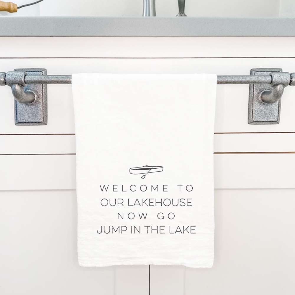 Welcome Lakehouse Cotton Tea Towel featuring a vibrant canoe design, made from 100% absorbent cotton.