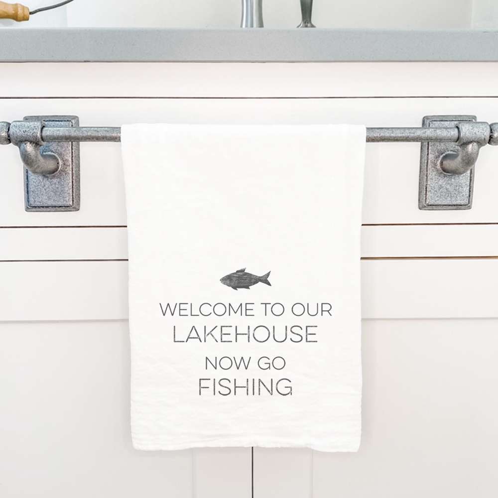 Welcome Lakehouse Cotton Tea Towel featuring a vibrant lakehouse fish design, made from 100% absorbent cotton.