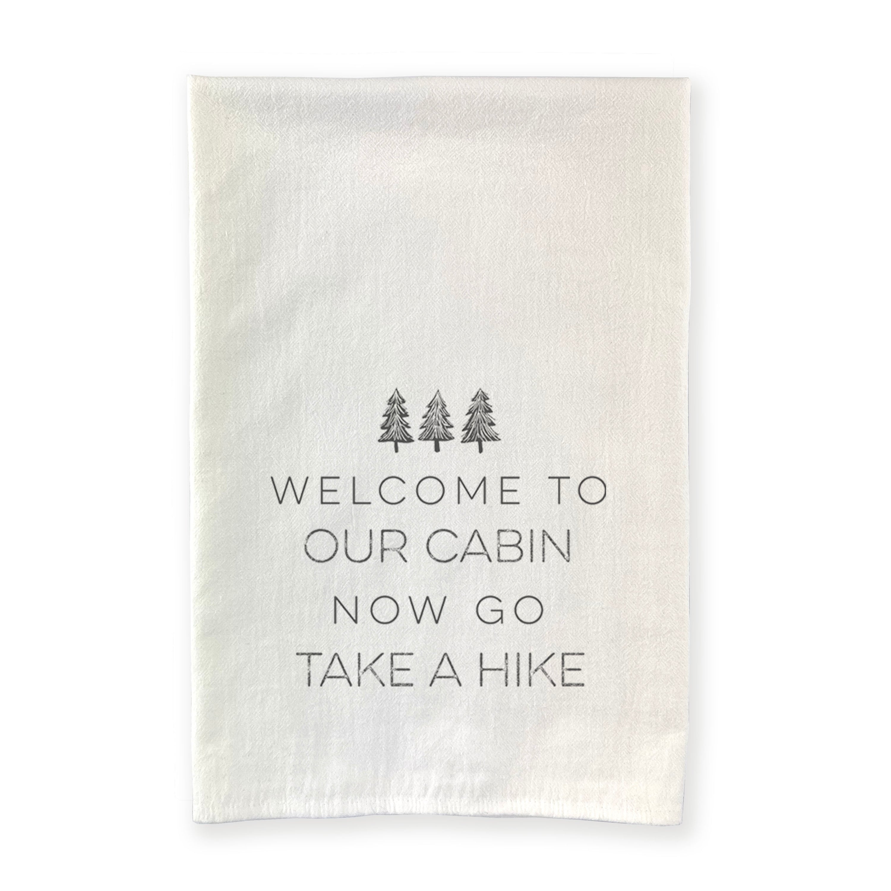 Welcome to Our Cabin cotton tea towel featuring a vibrant tree design, perfect for kitchen use.