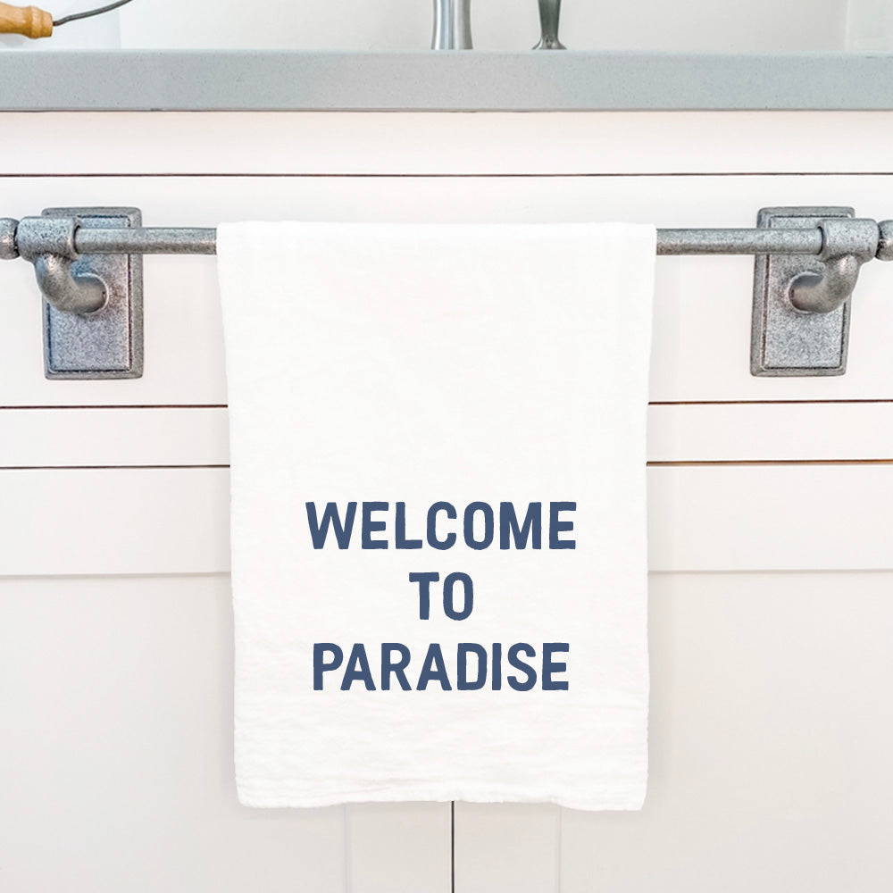 Welcome to Paradise cotton tea towel featuring vibrant designs, made from 100% absorbent cotton, perfect for kitchen use.