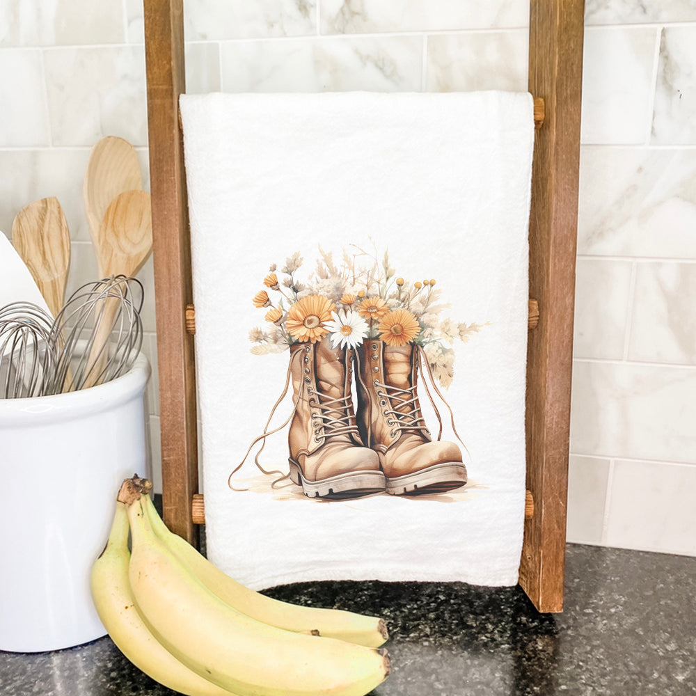 Wildflower Boots cotton tea towel featuring vibrant floral designs, hemmed edges, and a 27-inch square size, perfect for kitchen use.