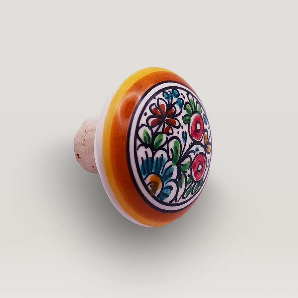 Handcrafted wine bottle stopper made of handpainted ceramic and cork, featuring a luxurious design and perfect round shape.