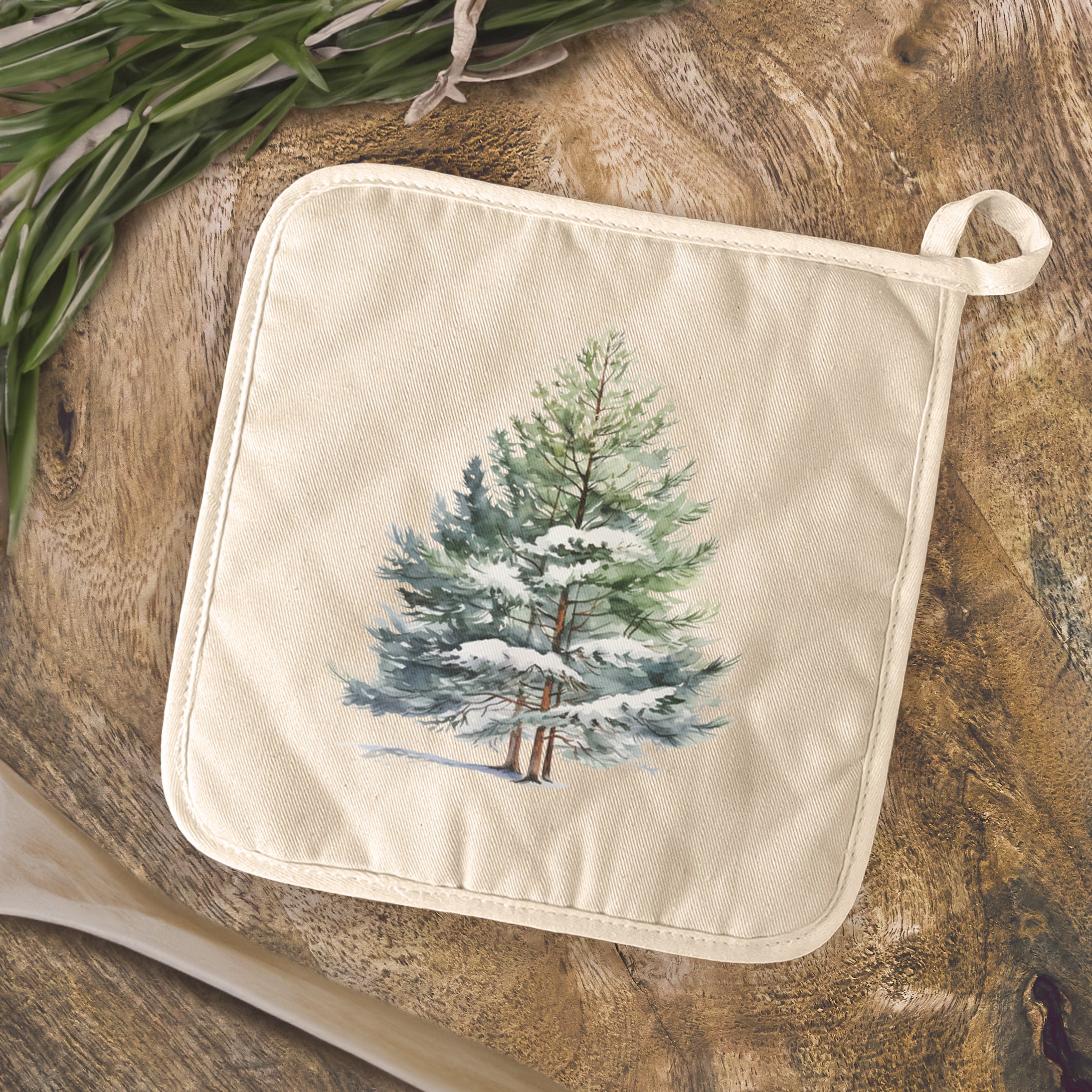 Winter Pine Trees cotton pot holder with a quilted terry cloth design, featuring a hanging loop for easy storage.