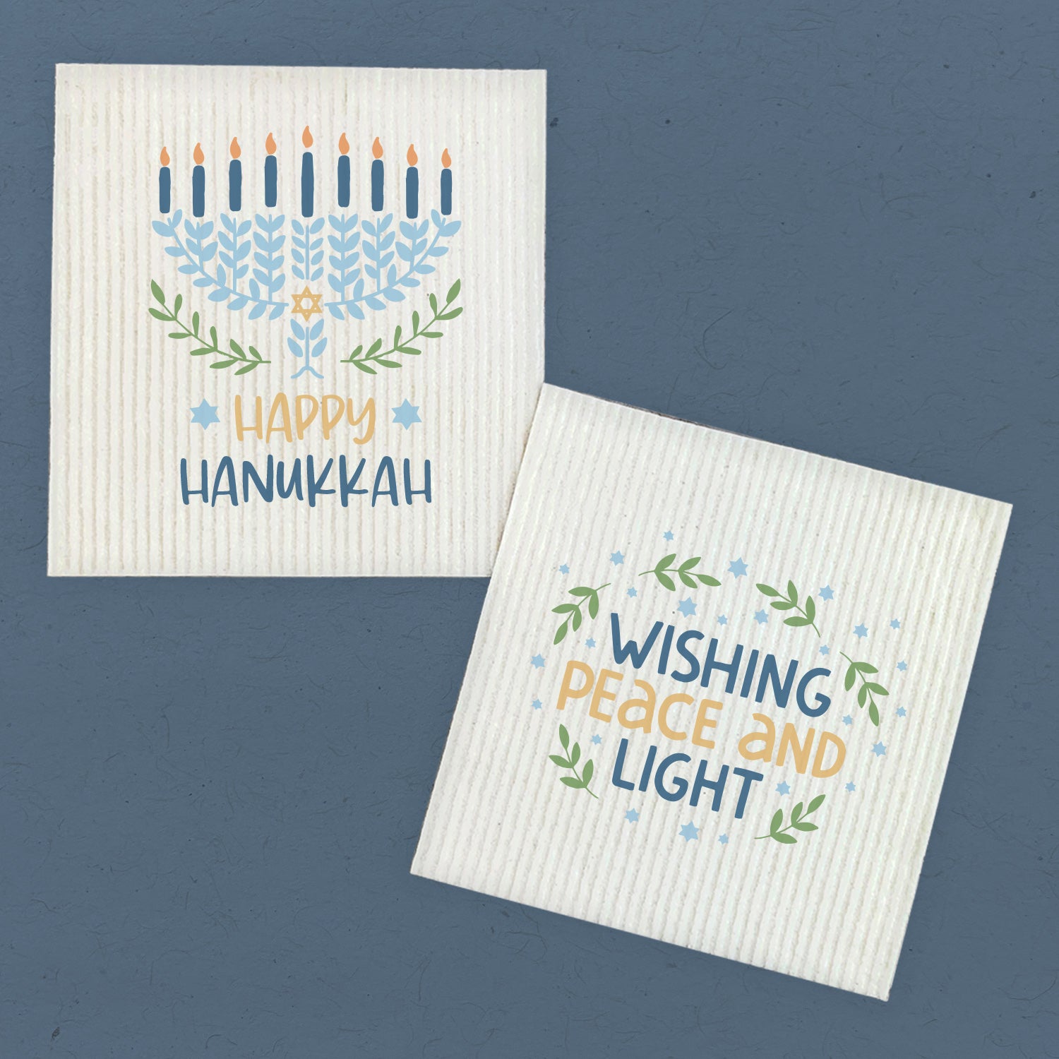 Two eco-friendly Swedish dish cloths with Hanukkah designs, showcasing vibrant colors and festive patterns, perfect for holiday cleaning.