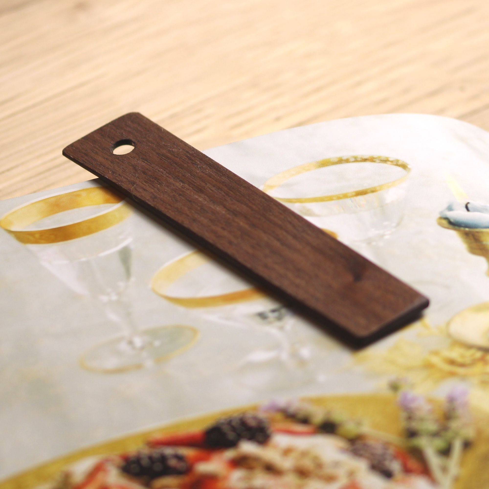 A set of 10 eco-friendly wooden bookmarks in various finishes, showcasing their customizable engraving options.