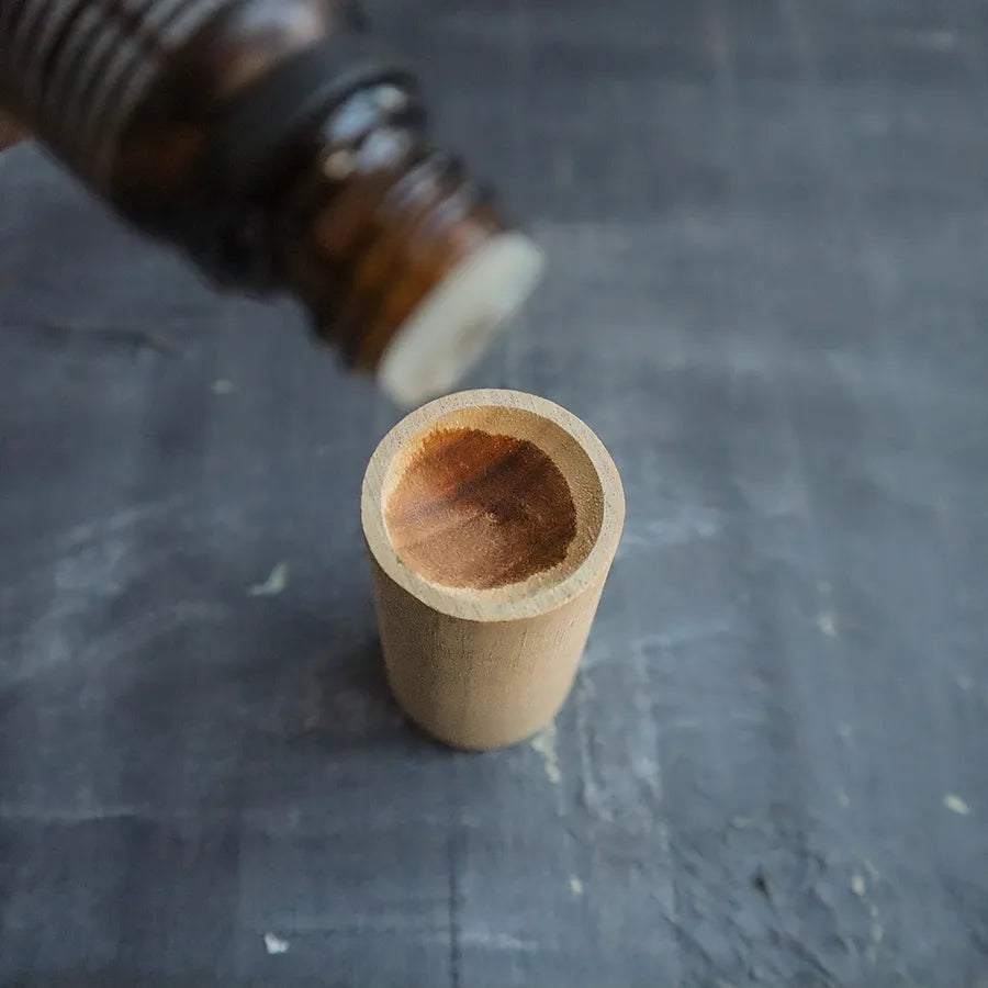 A beautifully crafted wooden essential oil diffuser, showcasing its natural wood grain and compact design, perfect for travel and aromatherapy.