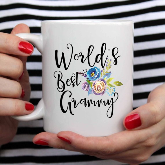 A white ceramic mug featuring the text 'World's Best Grammy' printed on both sides, showcasing a vibrant design.