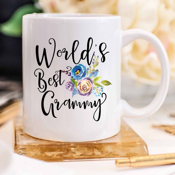 A white ceramic mug featuring the text 'World's Best Grammy' printed on both sides, showcasing a vibrant design.