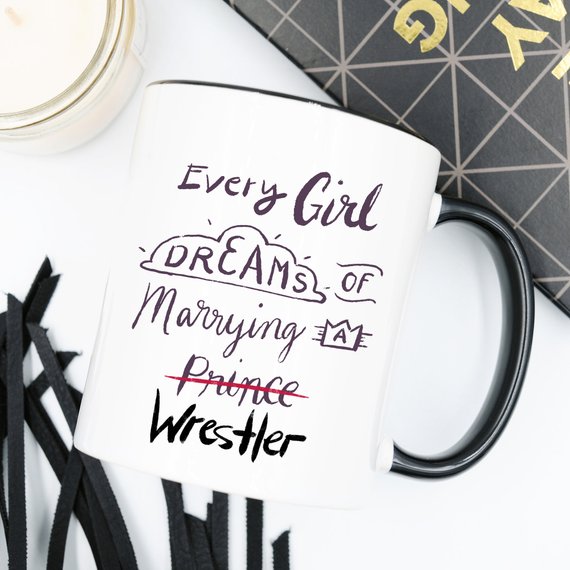 A humorous coffee mug featuring the phrase 'Every Girl Dreams Of Marrying A Wrestler', crafted from high-quality ceramic.