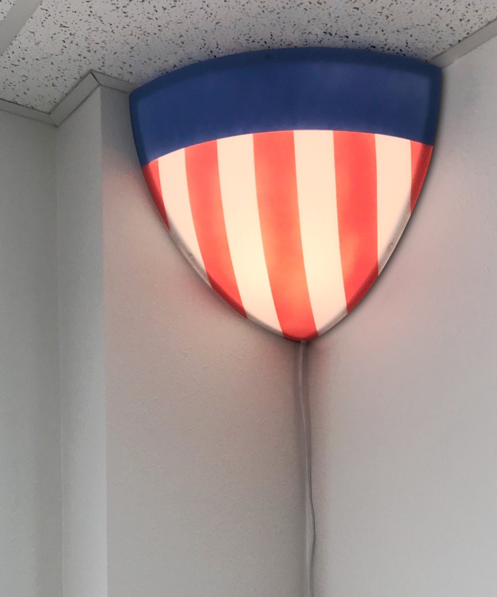 16-inch Beacon Triangle Corner Light with red, white, and blue acrylic diffuser, designed for easy installation in corners.