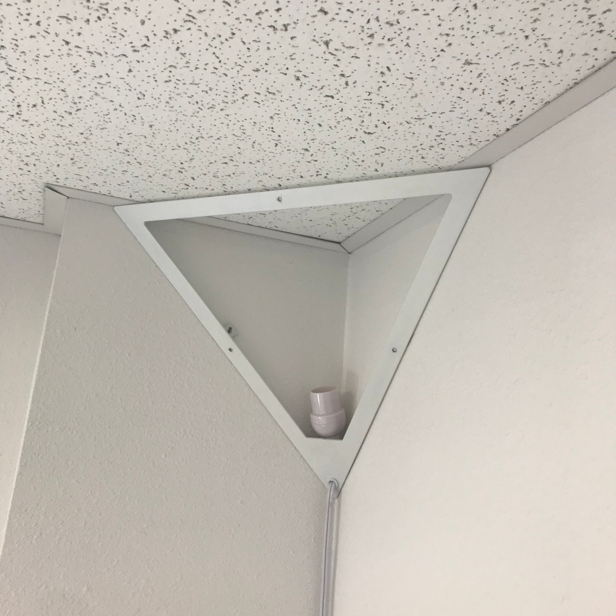 16-inch Beacon Triangle Corner Light in white, featuring a unique triangular design with a frosted acrylic diffuser, perfect for illuminating dark corners.