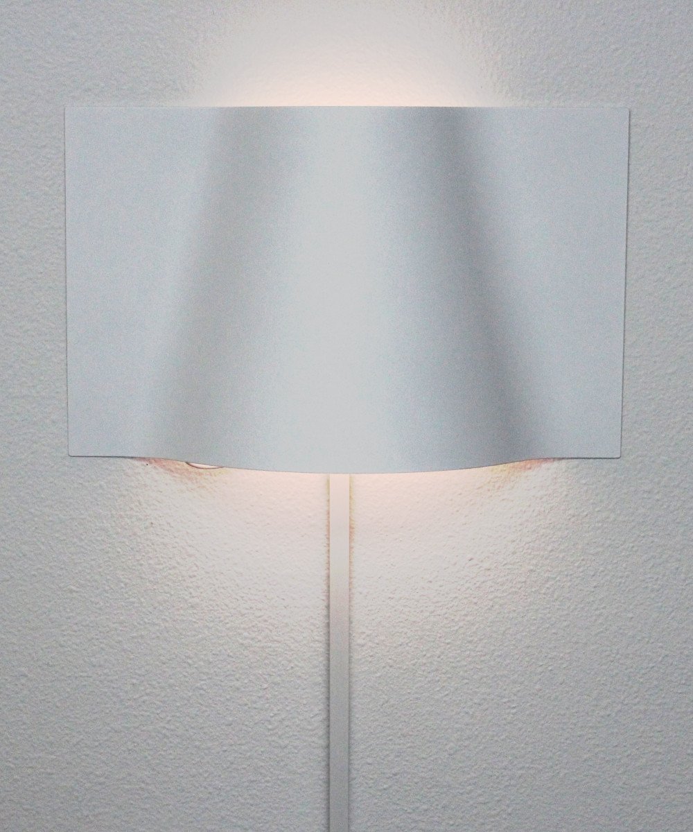 16-inch Surface Wave Curved Metal LED Wall Light with a unique wave design, mounted on a wall, showcasing its elegant and modern appearance.