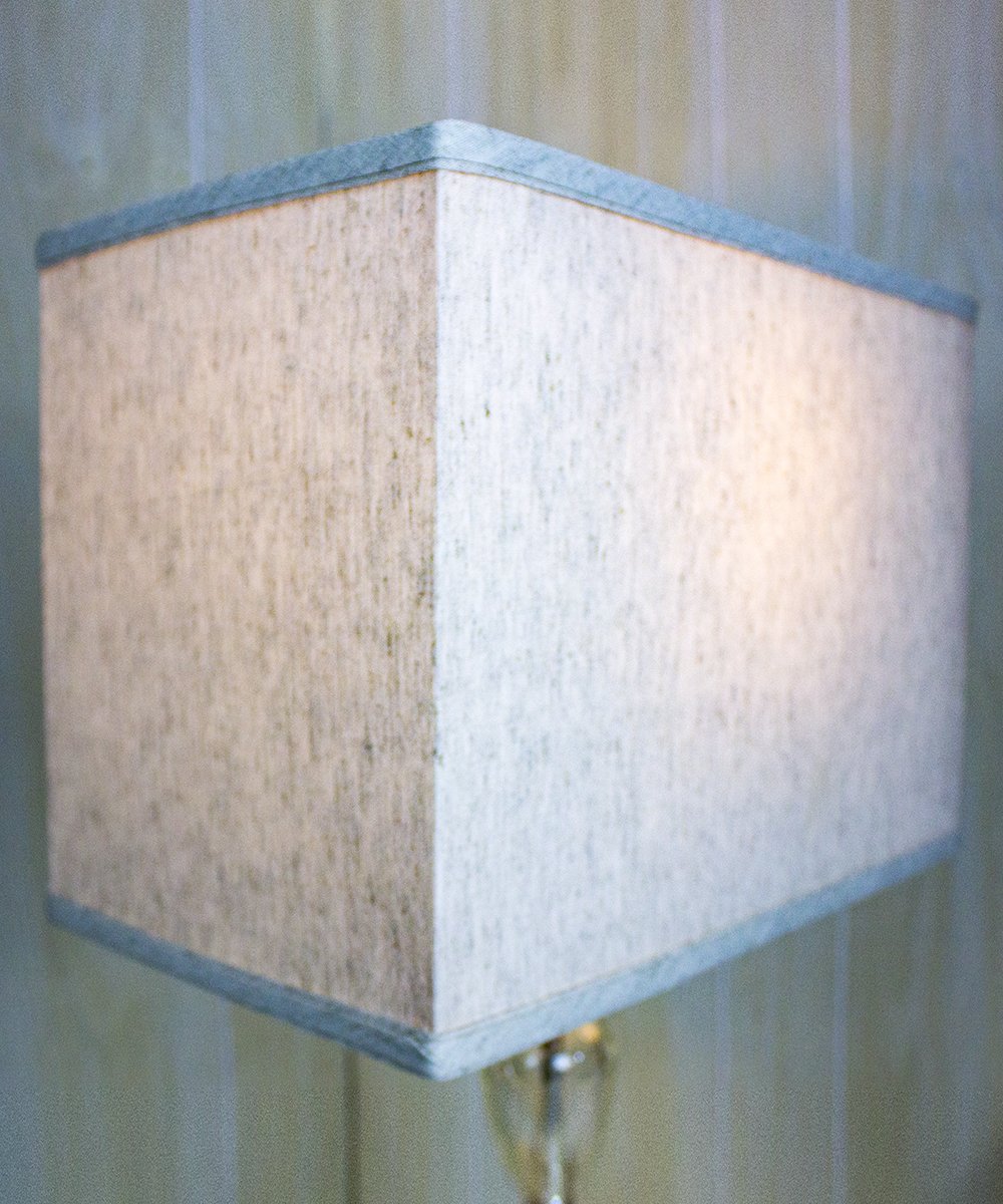 16-inch wide by 11-inch high rectangular drum lampshade in textured oatmeal fabric with white lining, featuring a spider fitter for easy installation.