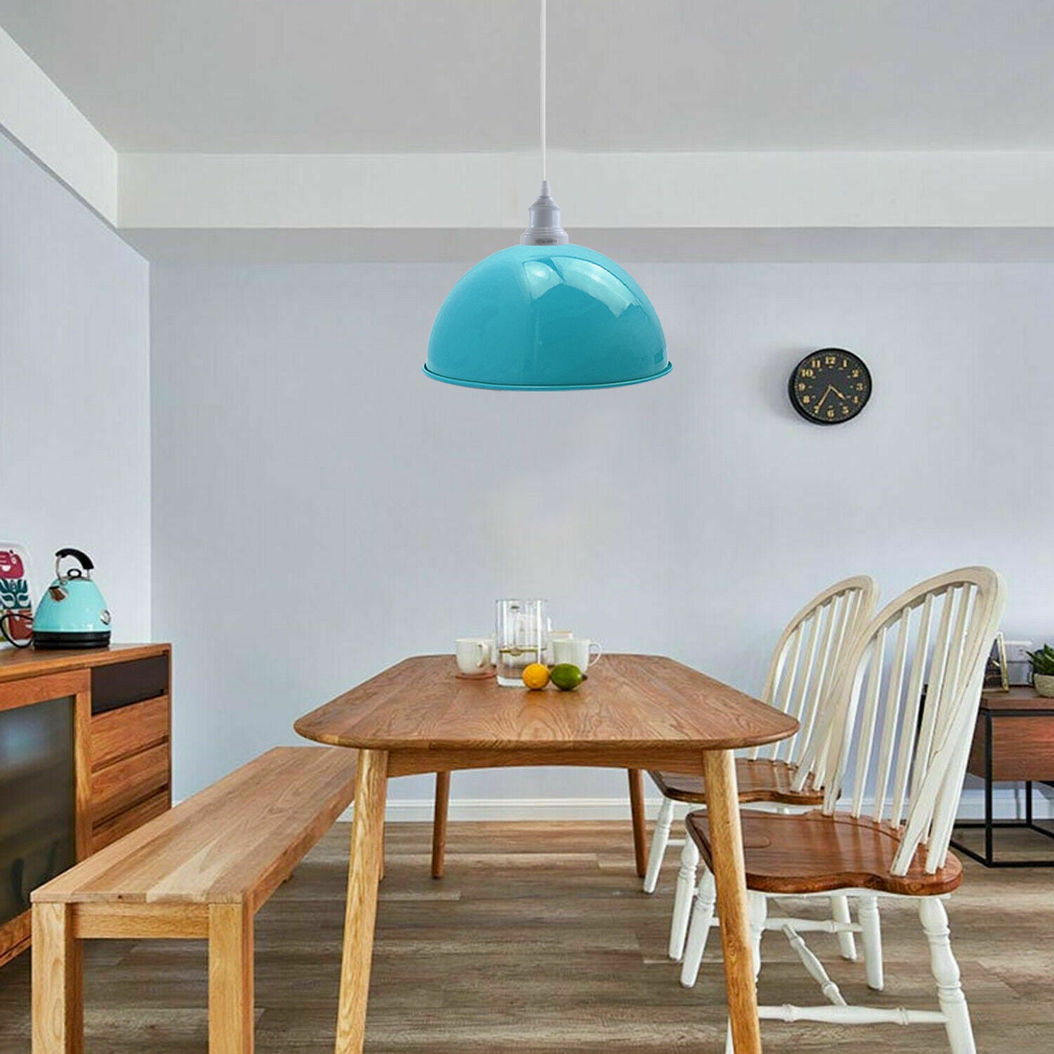 Two vintage industrial blue pendant lights hanging from a ceiling, showcasing a retro design with white lamp holders.