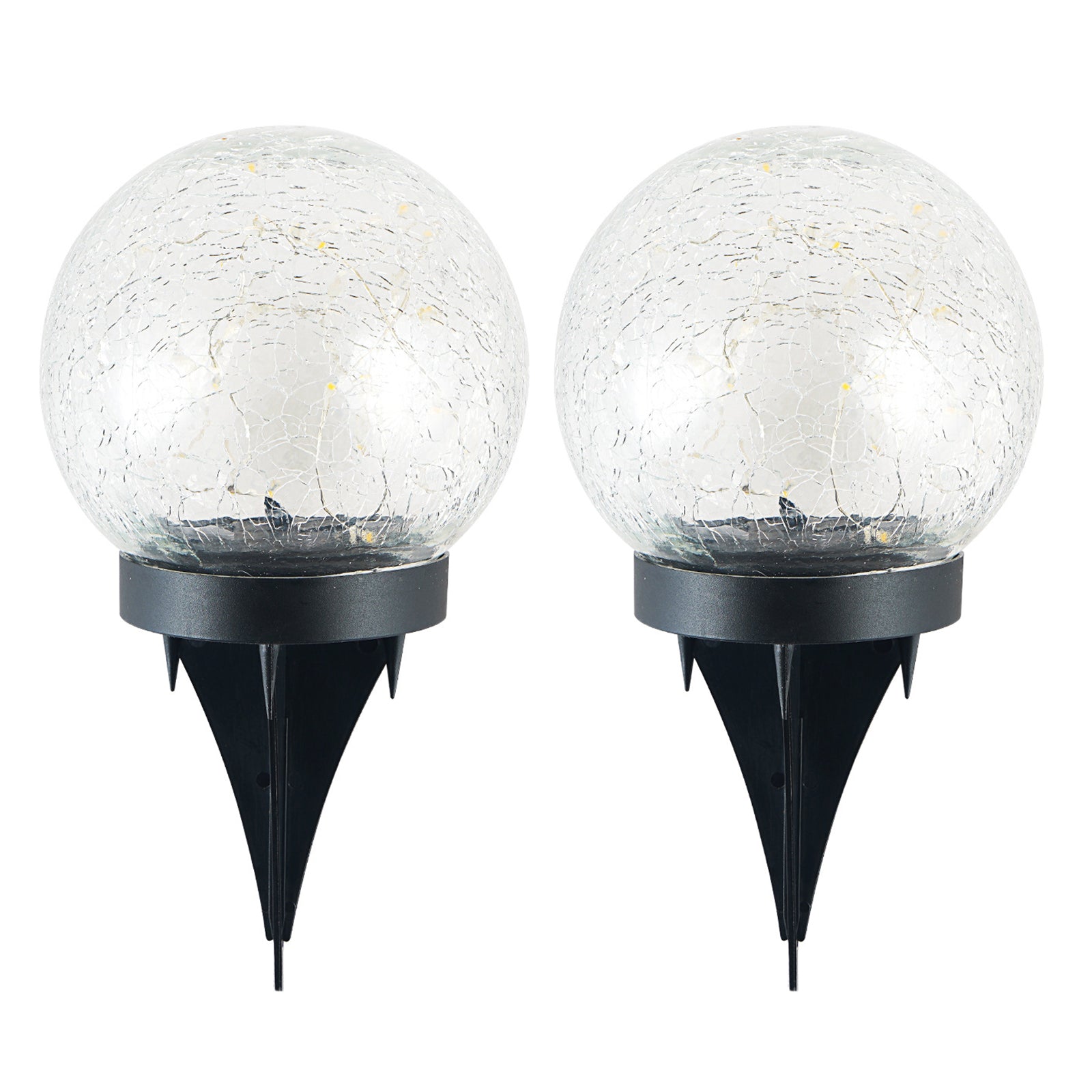 Two solar lights with cracked glass ball design illuminating a garden path at night, showcasing warm LED light patterns.